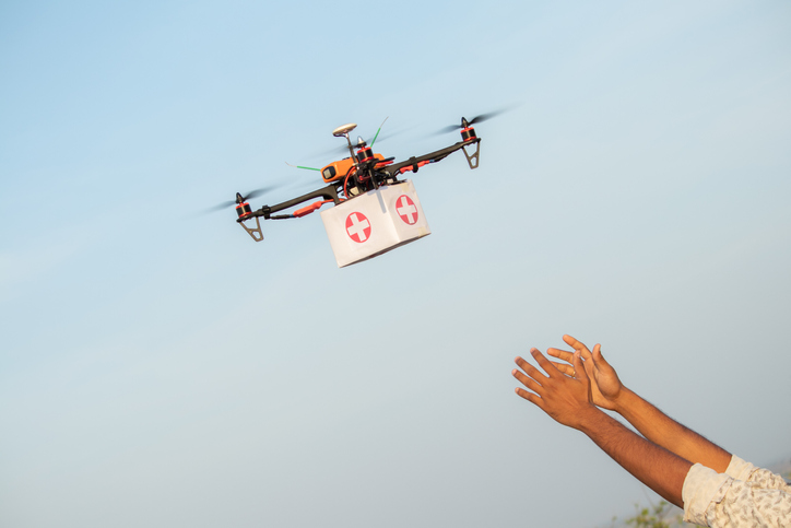 Drone Delivering First Aid Box or medicine to costumer hand during covid 19 or coronavirus lockdown   Advancing Medical Industry Logistics for Drug Transport concept.