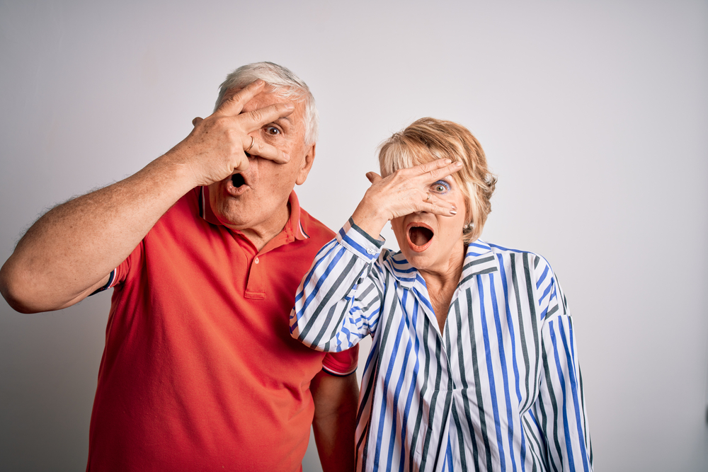 Senior,Beautiful,Couple,Standing,Together,Over,Isolated,White,Background,Peeking