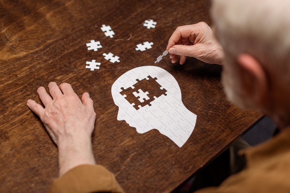 High,Angle,View,Of,Senior,Man,Collecting,Jigsaw,Puzzle,As