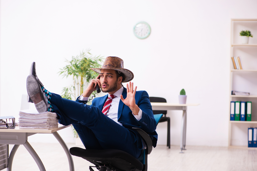 Young,Businessman,Cowboy,Working,In,The,Office